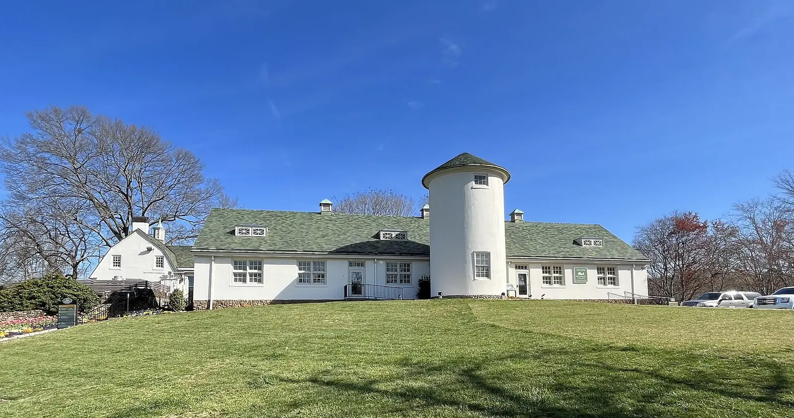 A white silo and farm buildings at Reynolda Village in Winston-Salem, home to shops and cafes including Dough-Joe's.