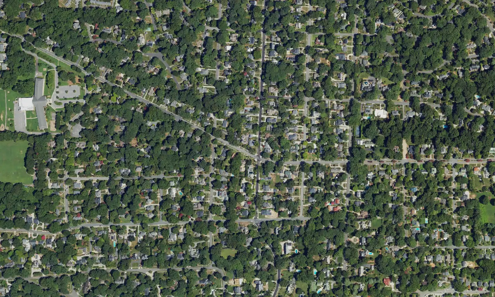 Aerial view of homes and wooded streets in the Buena Vista area of west Winston-Salem