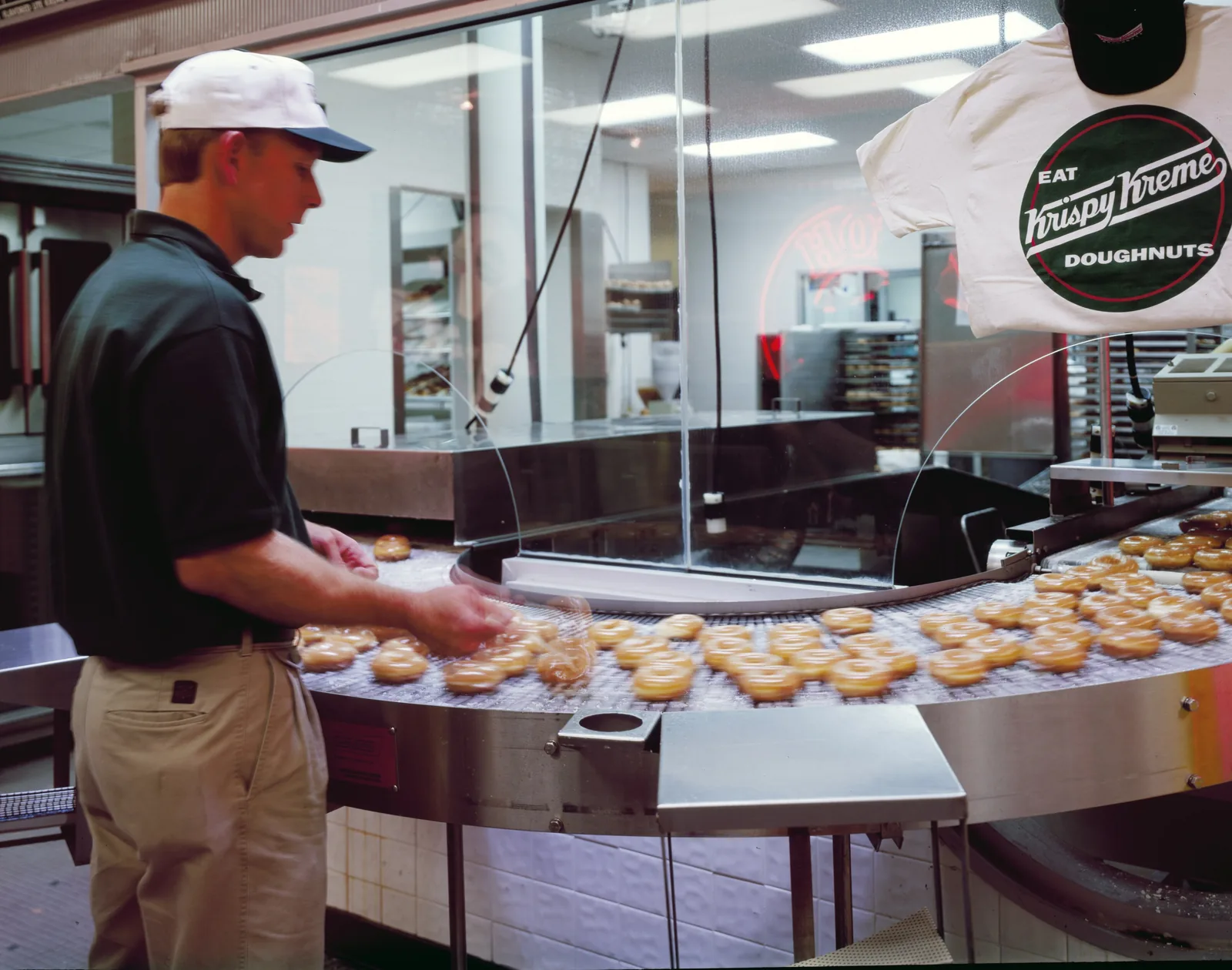 A worker tends the doughnut line at what the Library of Congress lists as the nation's first Krispy Kreme shop, in Winston-Salem.